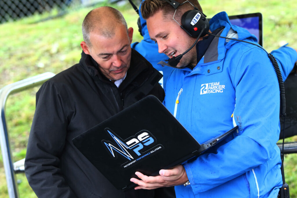 MPS Director Ben Newman analysing data with the BTCC team's engine support engineer.